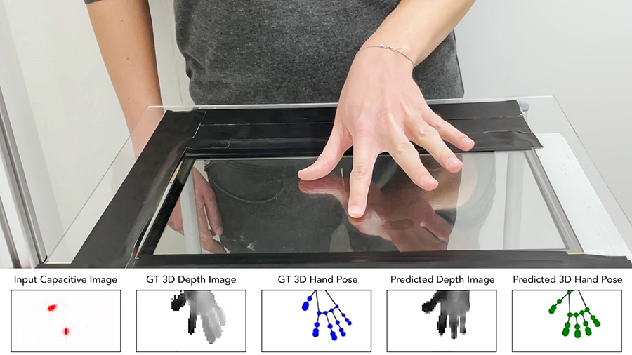 A person whose face isn't shown rests their hand on a horizonal glass surface. Below the image, computer models show data that respresents how the hand's pressure was distributed on that surface. 